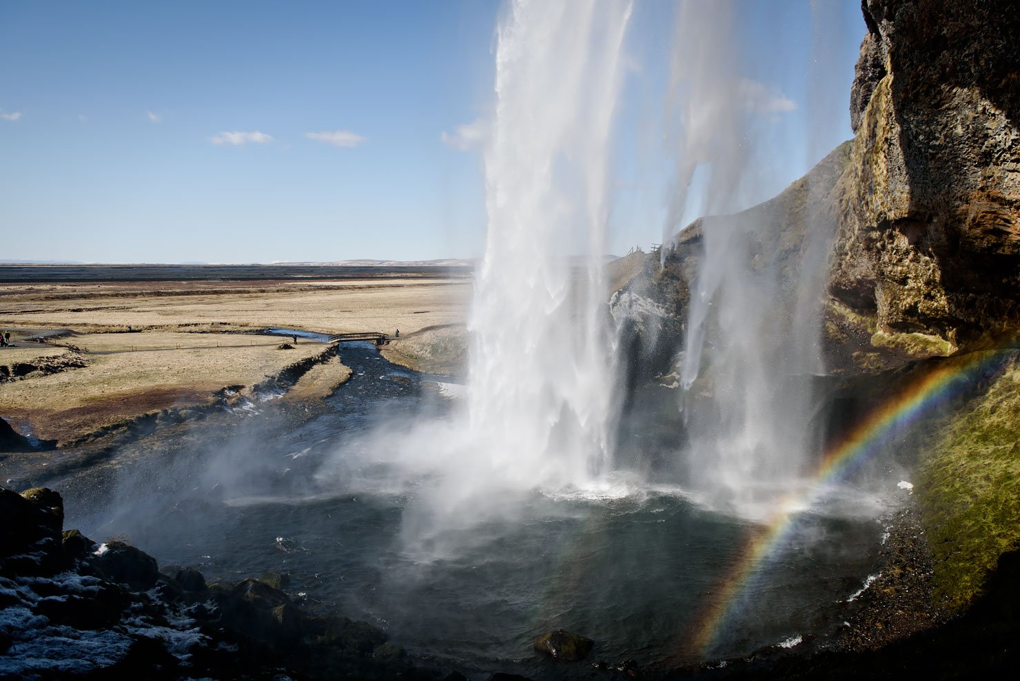 Road Trip in Iceland, the South Coast. Seljalandsfoss waterfall with rainbow.