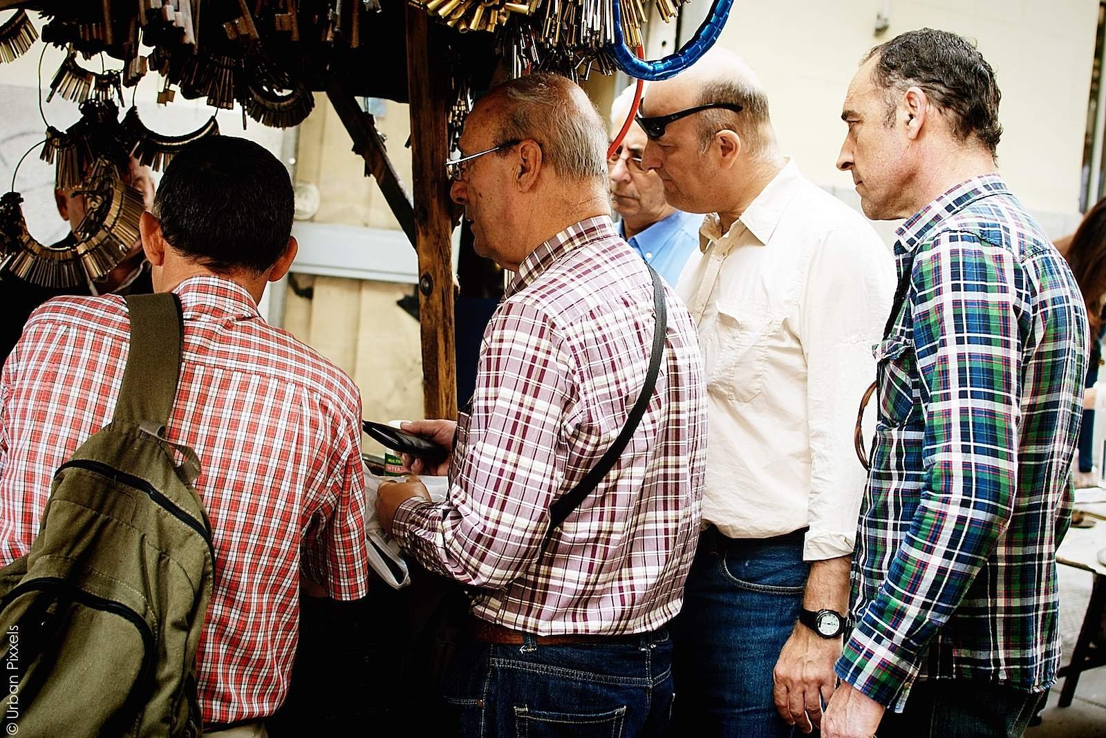 Spanish men listening at the el Rastro market in Madrid