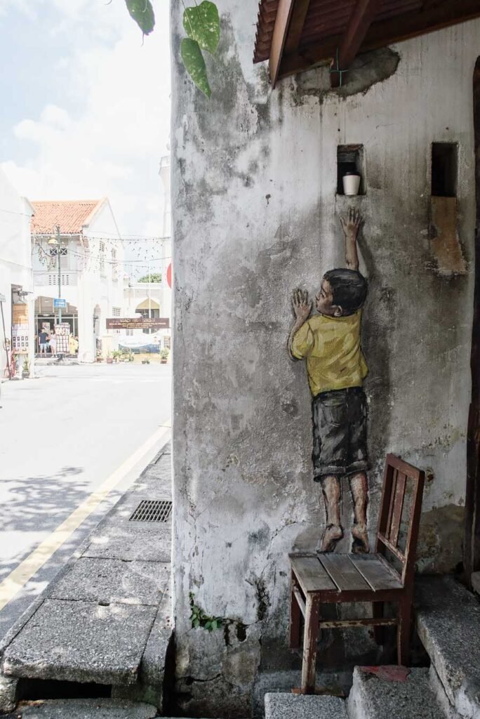 Photos that will make you want to visit Malaysia's Food Capital, George Town in Penang, Malaysia | Street art mural boy on chair