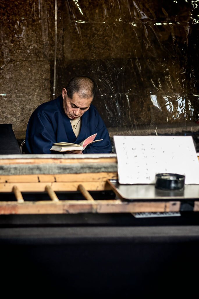 Man reading a book in Nara Park. Nara is a great day trip from Kyoto or Osaka.