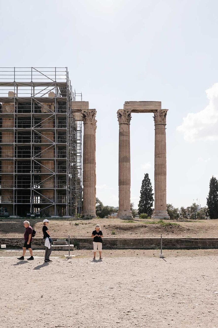 Tourists at Olympeion with Temple of Zeus in Athens