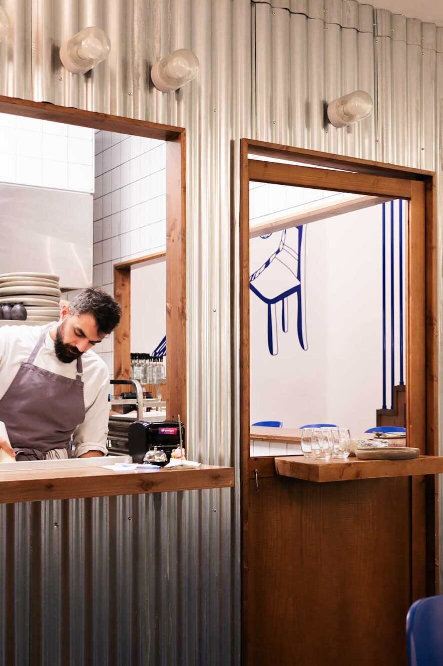 Chef preparing food in the kitchen of modern seafood restaurant Manu in Athens