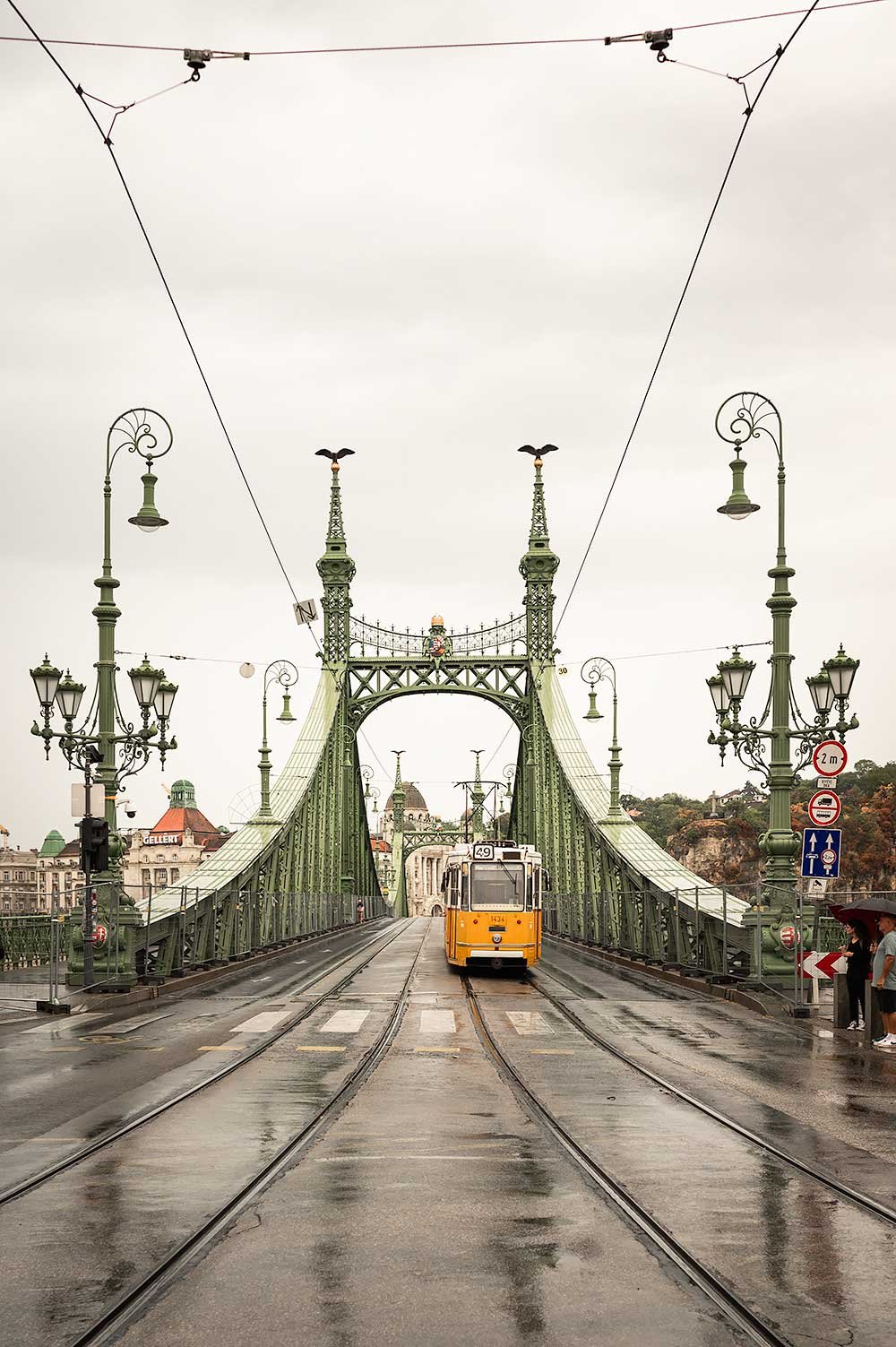 Liberty Bridge in Budapest with iconic yellow tram crossing the Danube river