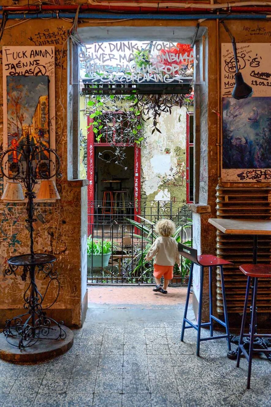 Child walking around ruin bar Szimpla Kert, one of the things you have to do on your first visit to Budapest