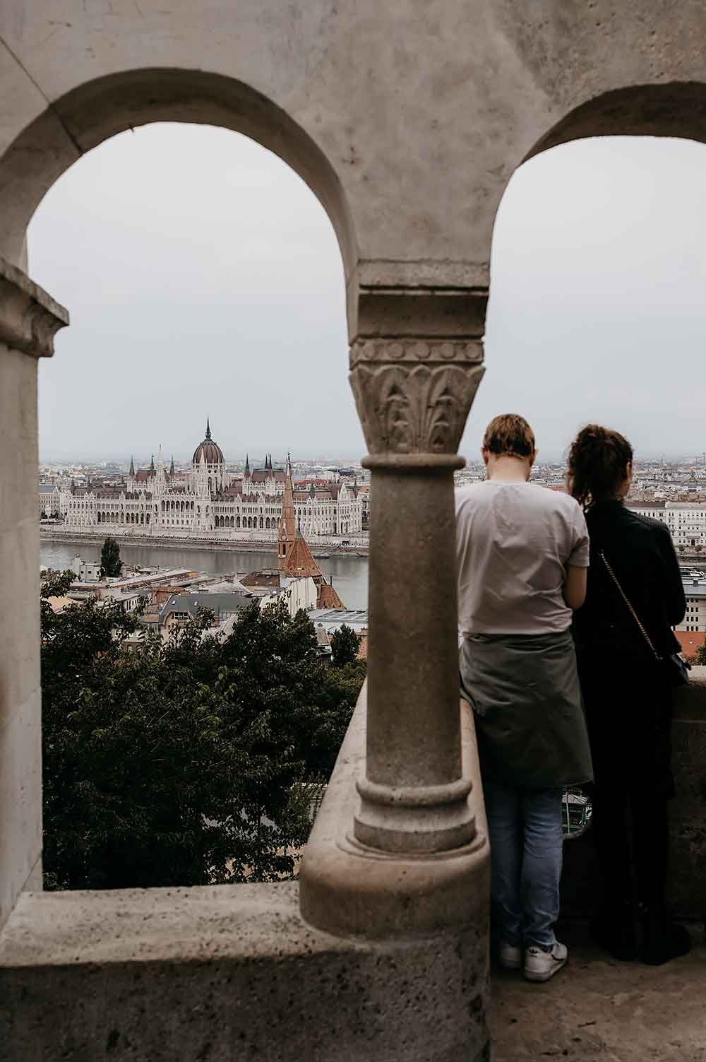 People looking at the Hungarian Parliament building from Fisherman's Bastion