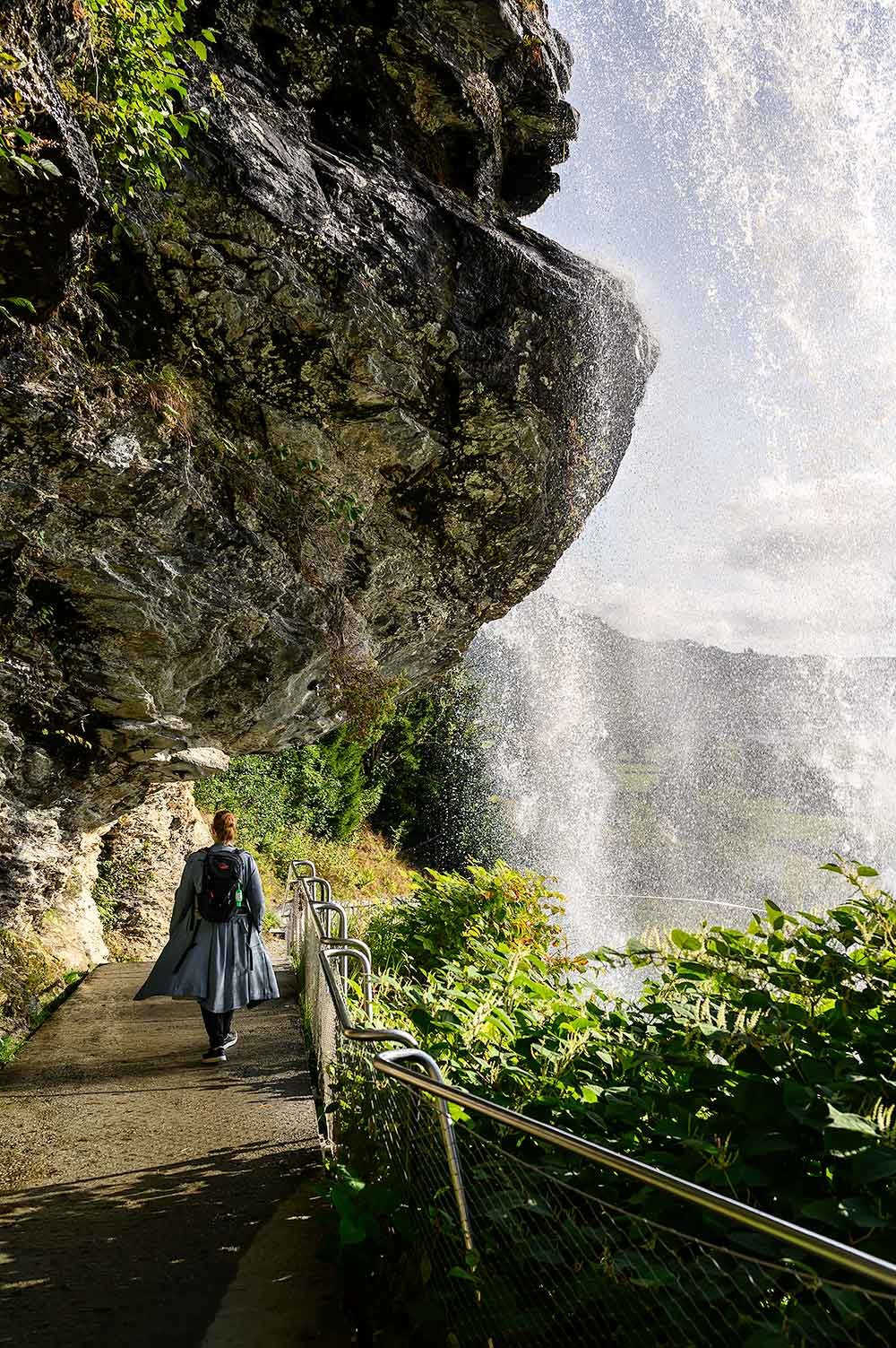 Walking behind the Steinsdalsfossen waterfall in Norway near Bergen
