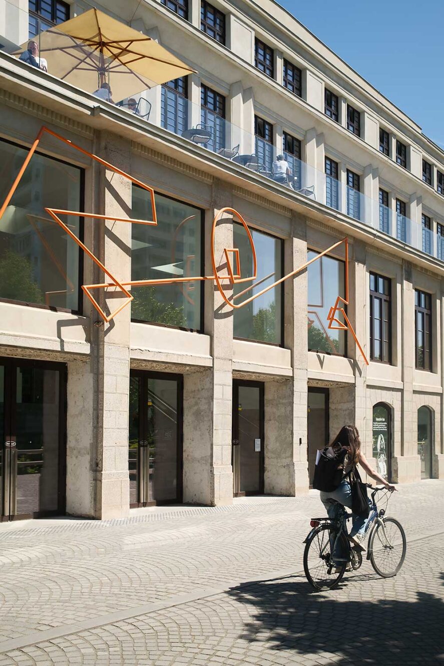 Woman cycling past Center Rog, a creative hub in Ljubljana