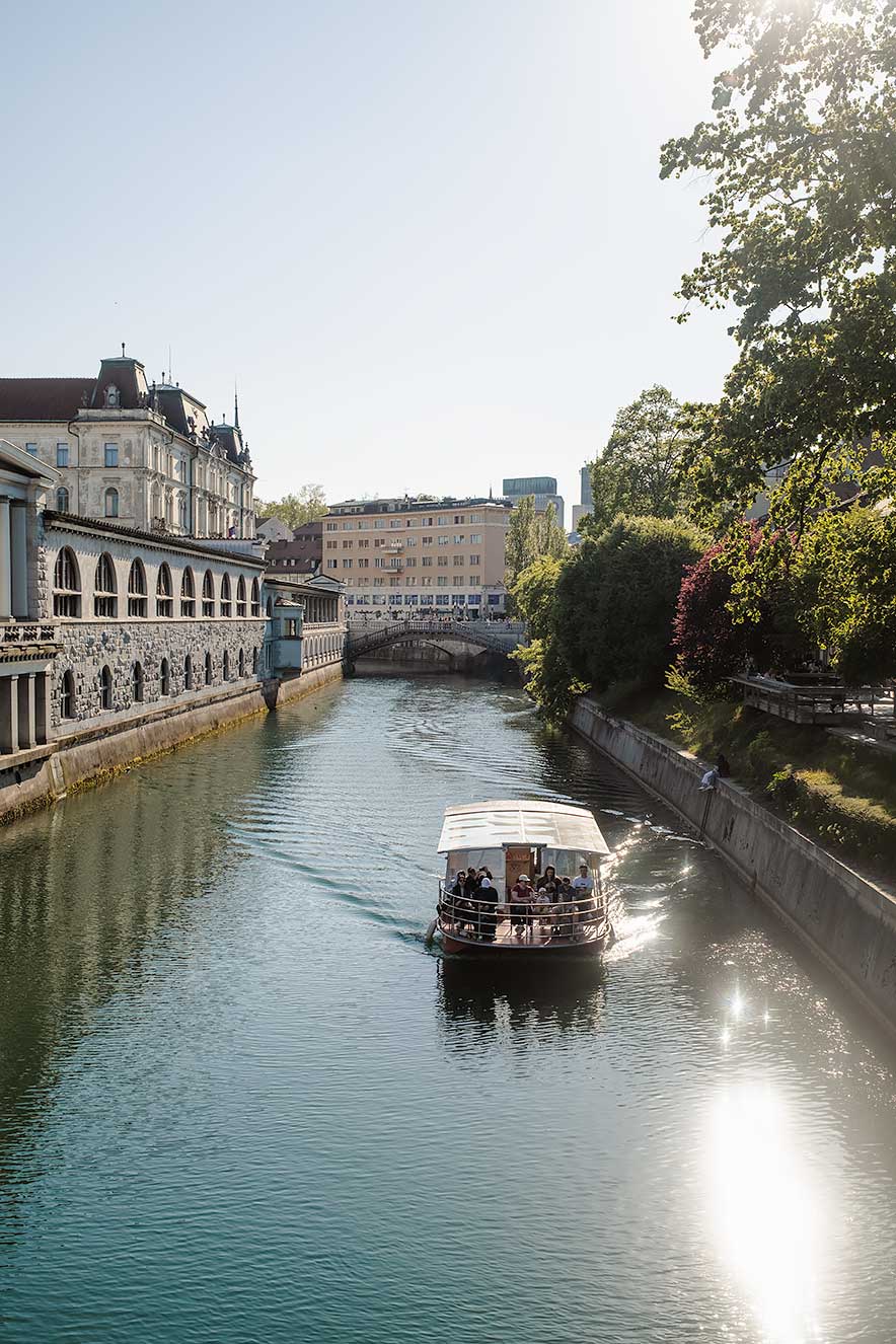 Boat cruise on the Ljubljanica River passing Plecnik Arcades