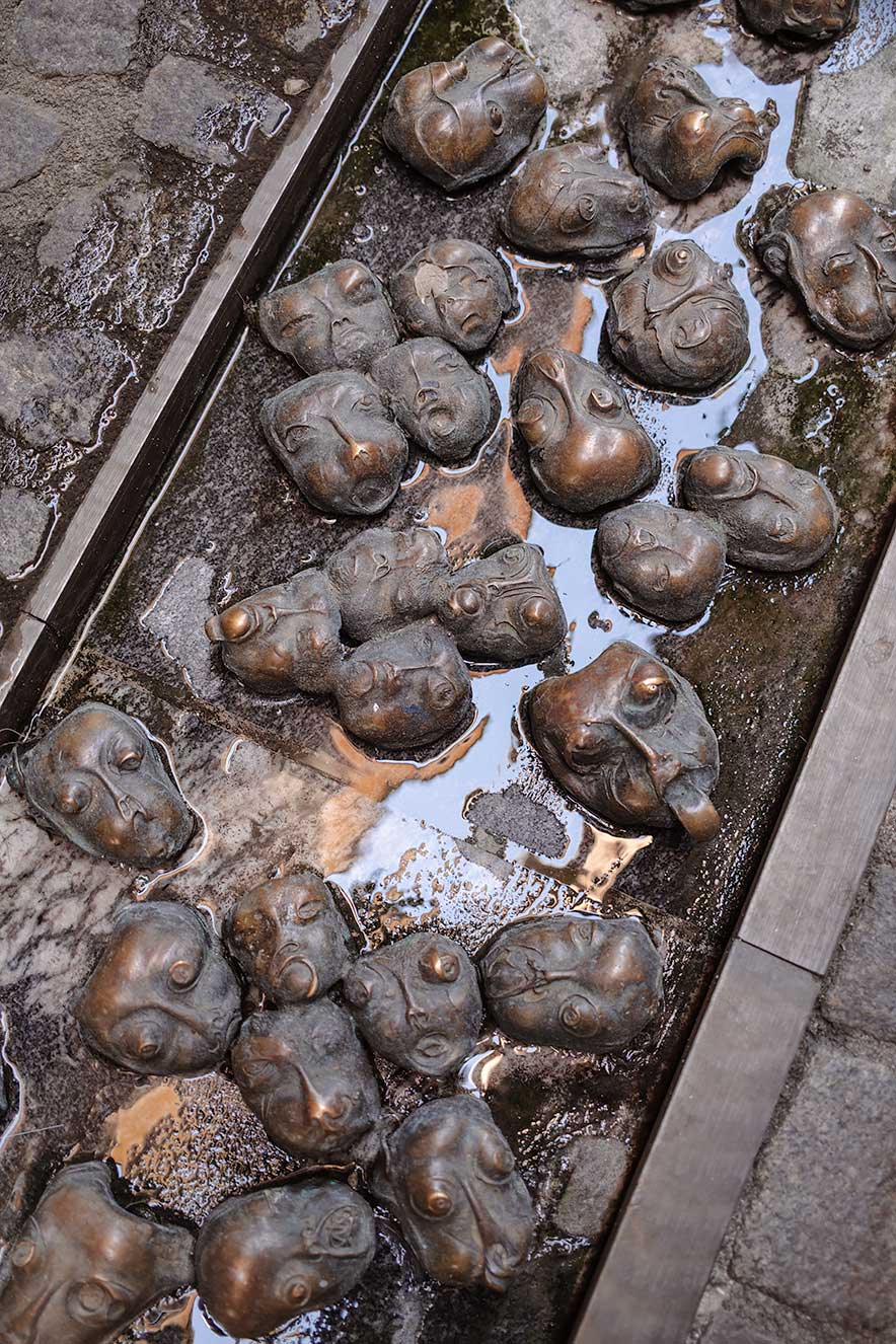 bronze installation Faces by Slovenian artist Jakov Brdar in Ljubljana