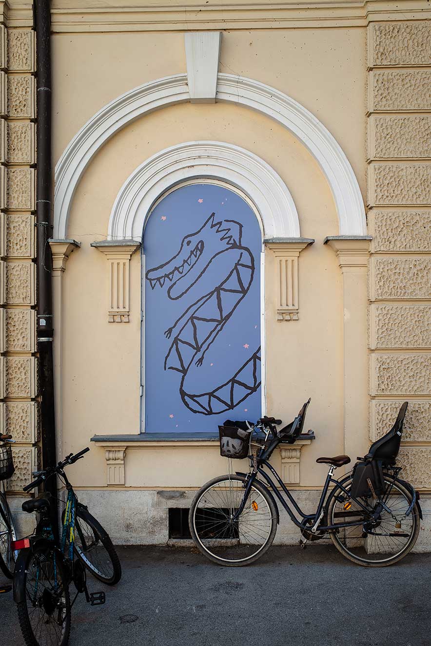 Mural of a dragon with a parked bike in Ljubljana